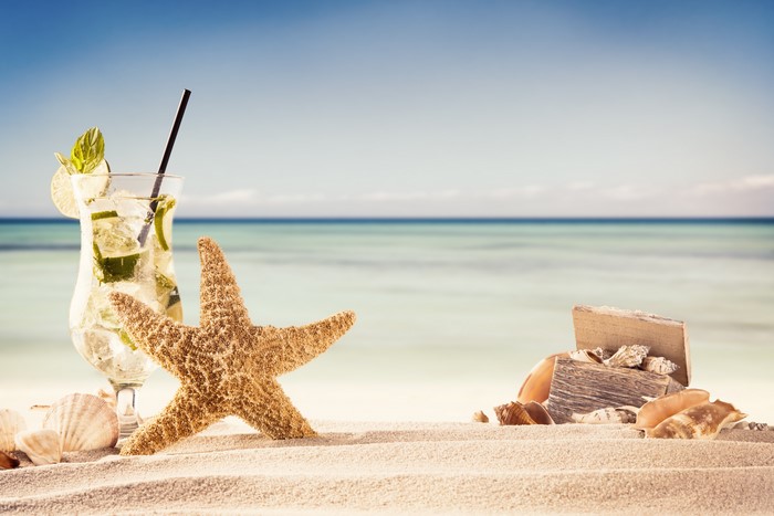 Starfish and Cocktail on a Sandy Beach