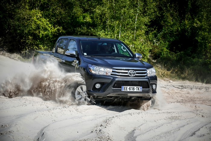 Dark Grey Toyota Hilux 4x4 Double Cab driving on sand