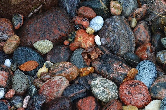 Close-up of many wet, colorful stones