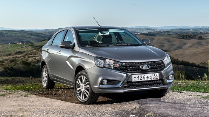 Grey Lada Vesta sedan parked on a dirt road
