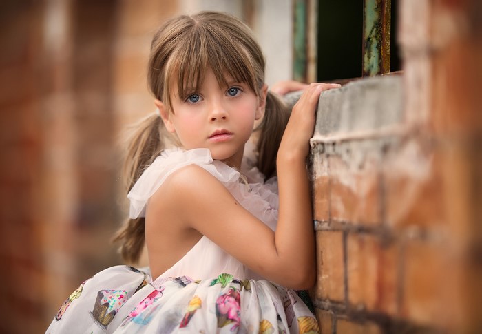 Little girl with pigtails in a cupcake dress