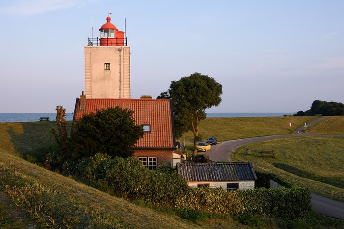 Lighthouse and houses on IJsselmeer, Netherlands