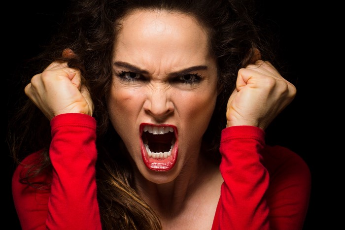 Woman screaming with fists raised