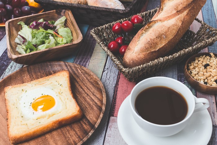 Breakfast with Bread, Fried Egg, Coffee, and Salad