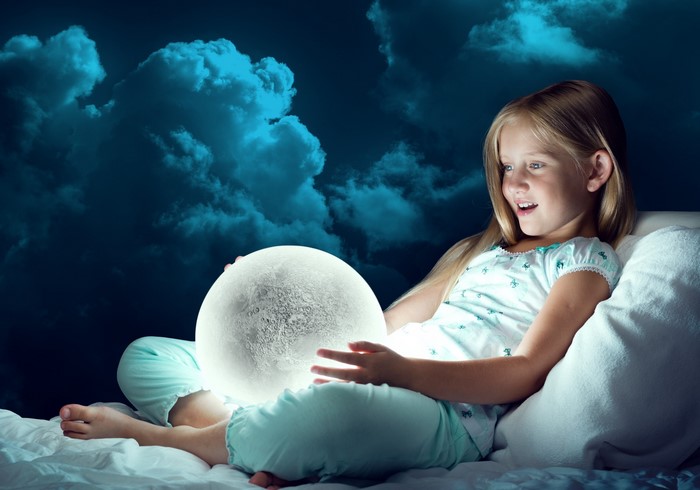 Girl holding a glowing moon ball