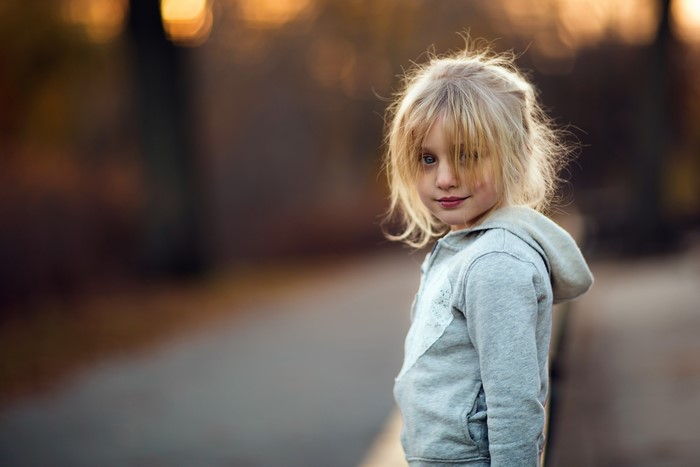 Blonde girl in a grey hoodie