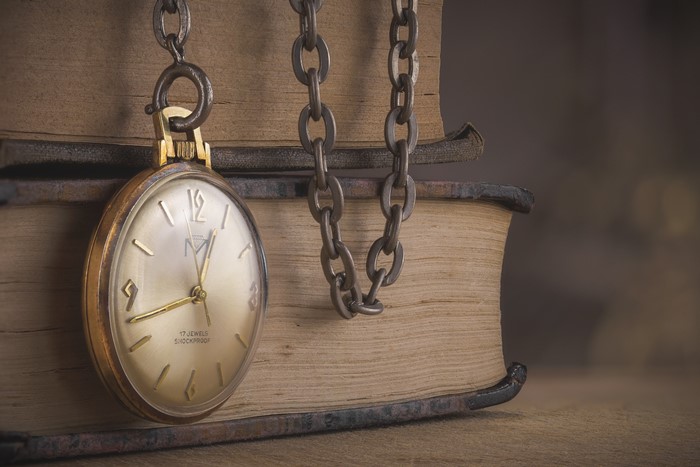Pocket watch on a chain with books