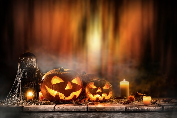 Halloween pumpkins and candles on a wooden table