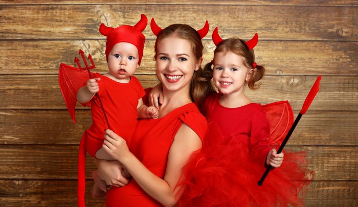 Mother and children in devil costumes