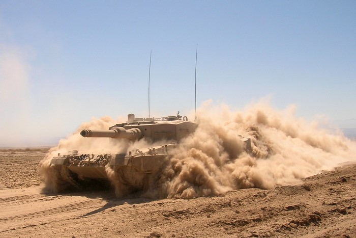 Leopard 2 tank driving through dust