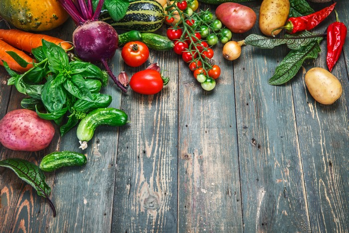 Assortment of fresh vegetables on wooden planks