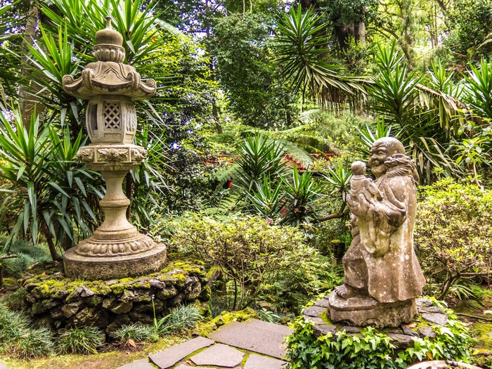 Stone lantern and statue in a garden