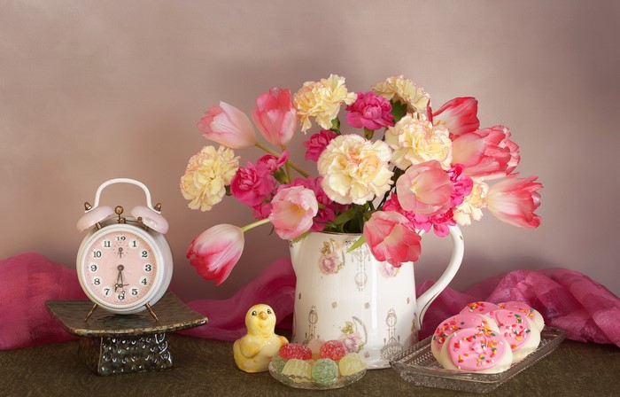 Still-life with tulips, carnations, cookies, and alarm clock