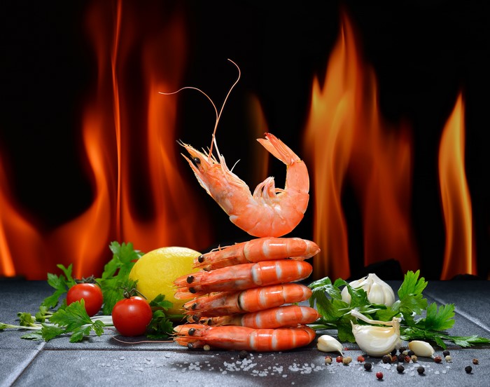 Shrimp on a grill with flames
