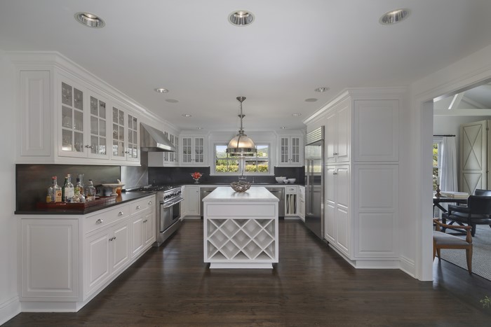 Modern white kitchen with island and dining area