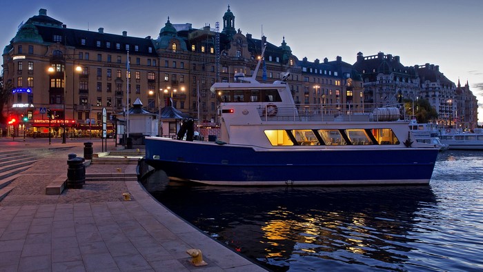 Boat docked in Stockholm harbor at dusk