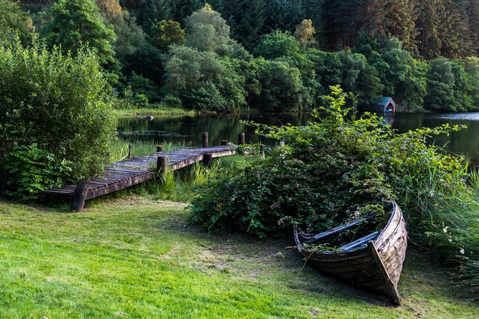 Wooden boat and pier on a lake in Scotland
