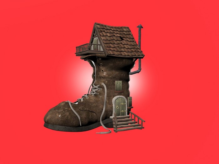 A house built inside a brown boot on a red background