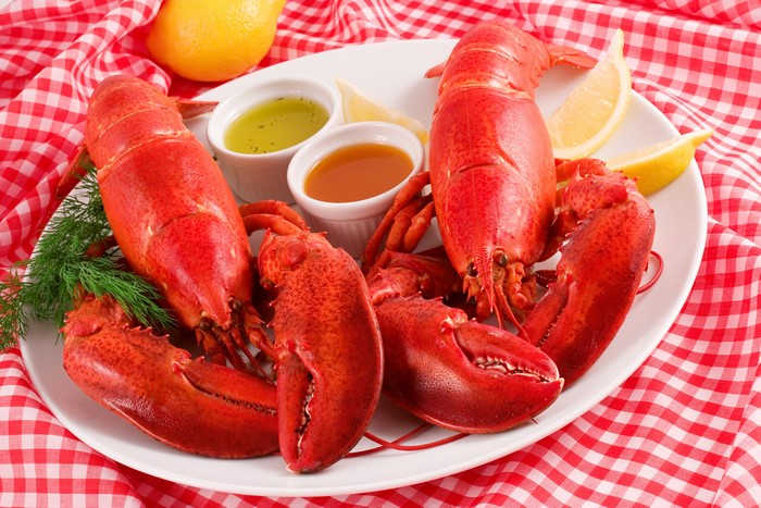 Two Lobsters with Lemon and Dips on Plate