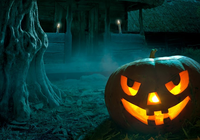 Halloween pumpkin with candles and spooky tree
