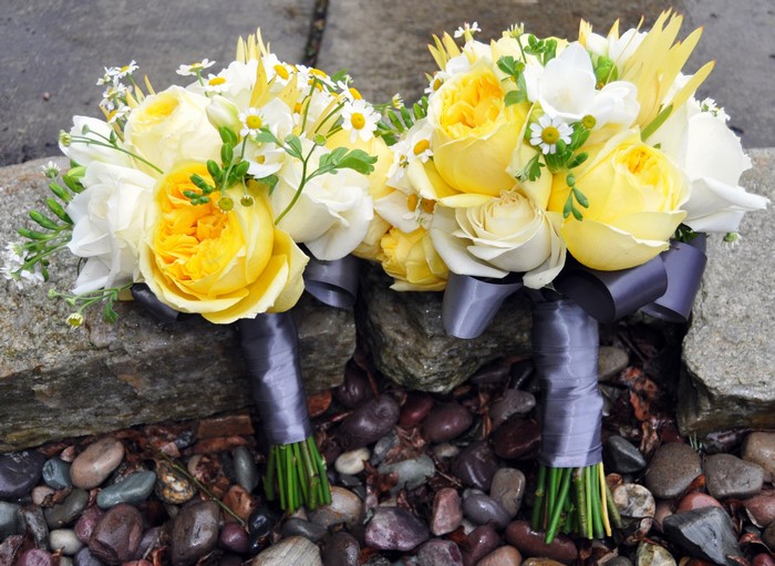 Two yellow and white rose bouquets with grey ribbon