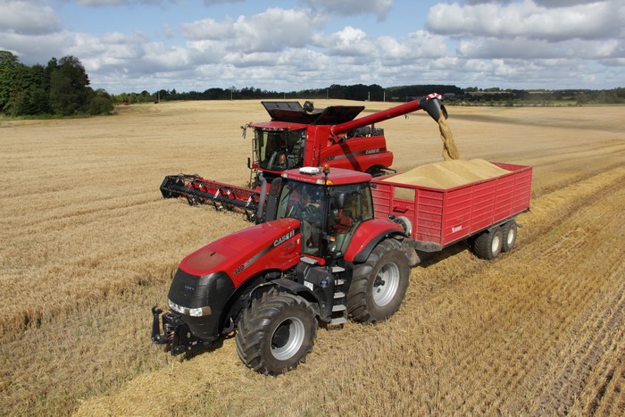 Case IH combine harvester and tractor harvesting a field