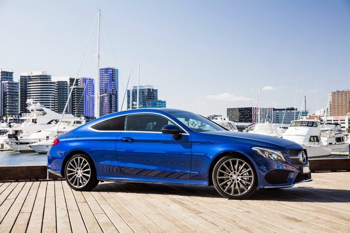 Blue Mercedes-Benz C-Class Coupe parked by a marina