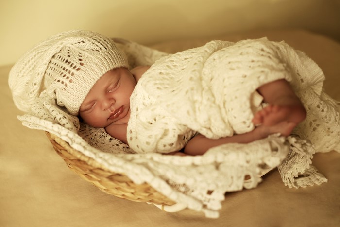 Newborn baby sleeping in a basket