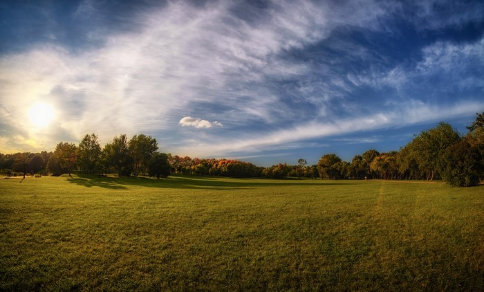 Loshitski park in Minsk, Belarus with a vast green lawn and trees