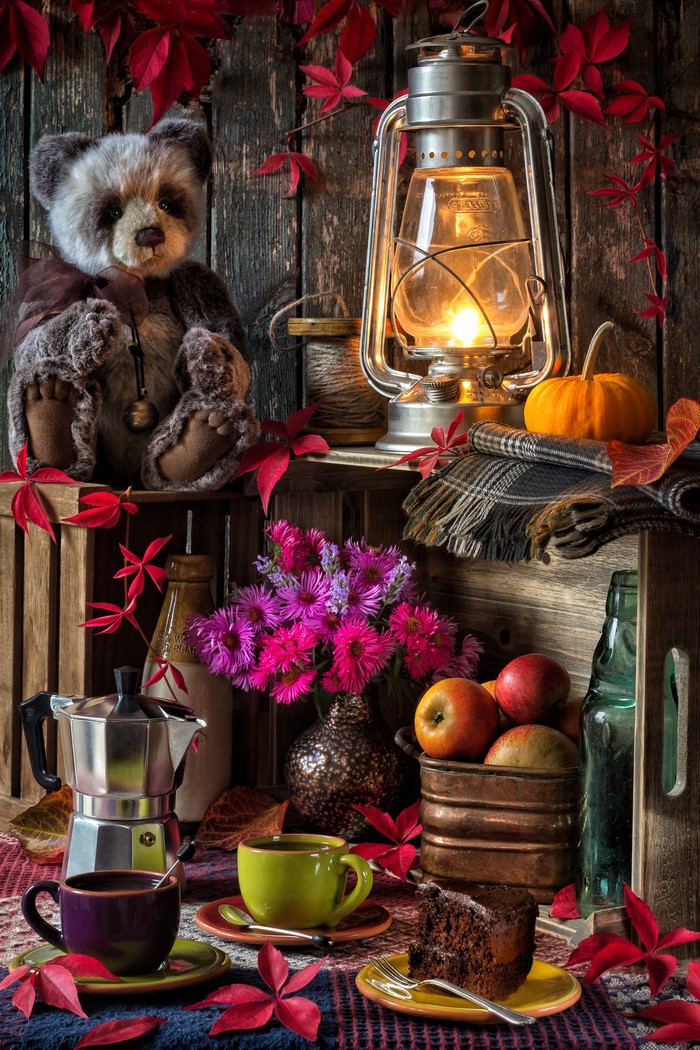 Still life with teddy bear, lantern, and coffee