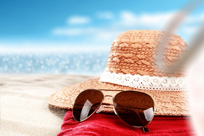 Beach scene with hat and sunglasses
