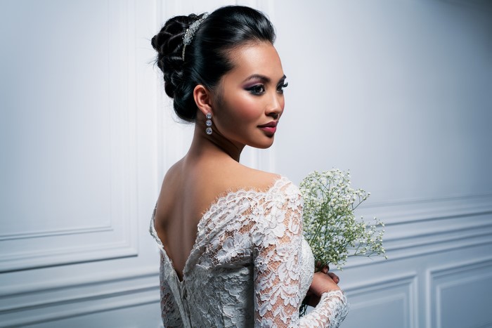 Bride in Lace Wedding Dress with Bouquet