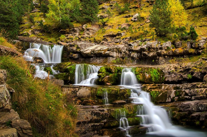 Waterfalls cascading over mossy rocks in Ordesa, Aragon, Spain