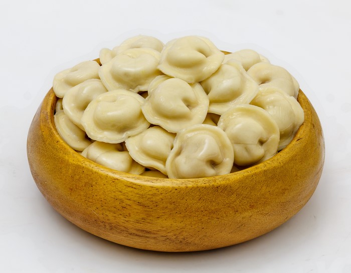 Pelmeni in a wooden bowl