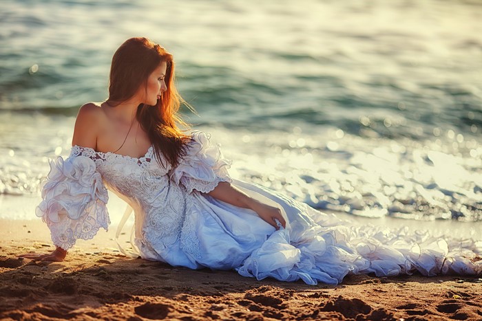 Woman in a white dress on a beach