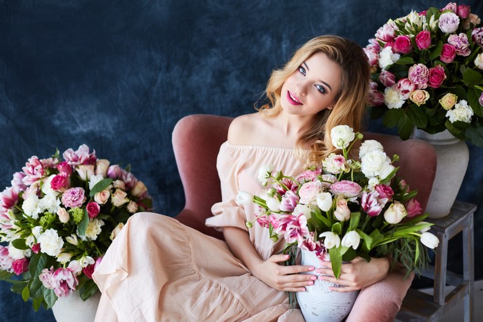 Woman in a dress holding a bouquet of flowers