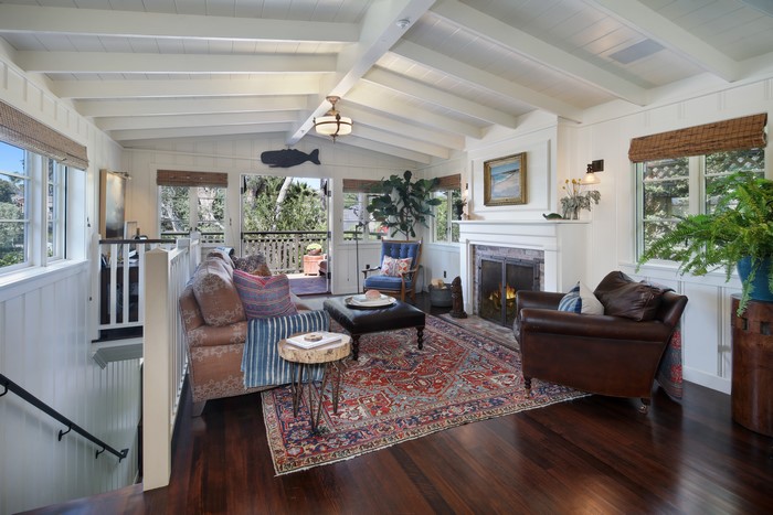 Living room with sofa, armchair, and fireplace