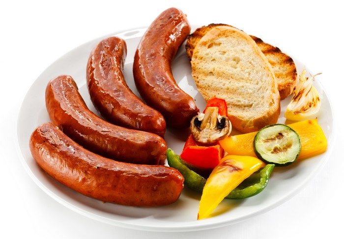 Sausages with bread and grilled vegetables on a plate