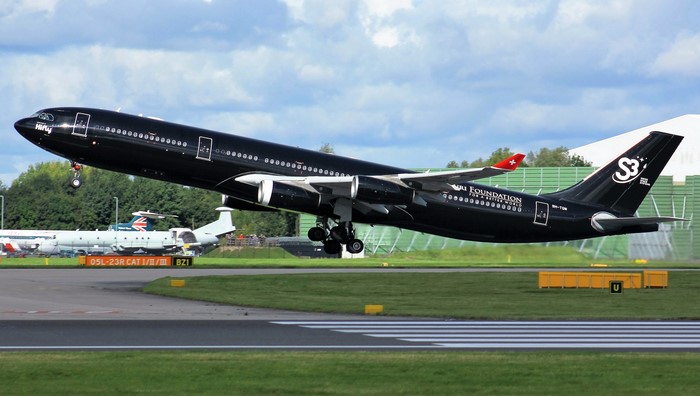 Black Airbus A340-313 taking off