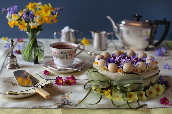 Still-life of a cake with tea and flowers