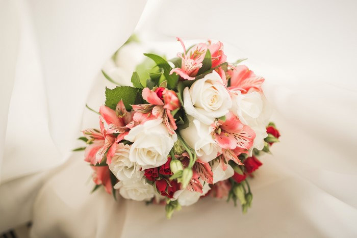 Bouquet of Roses and Alstroemeria on White Fabric