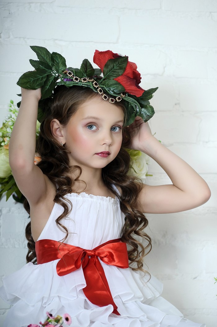 Young Girl in White Dress with Floral Crown