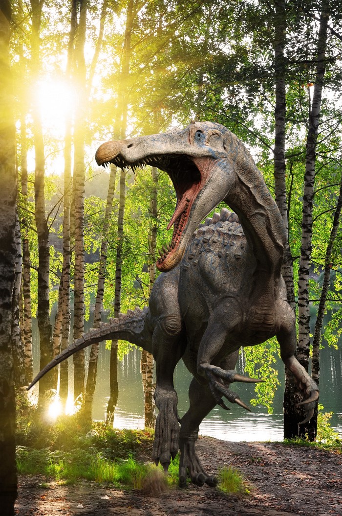 Suchomimus dinosaur in a forest with sun rays