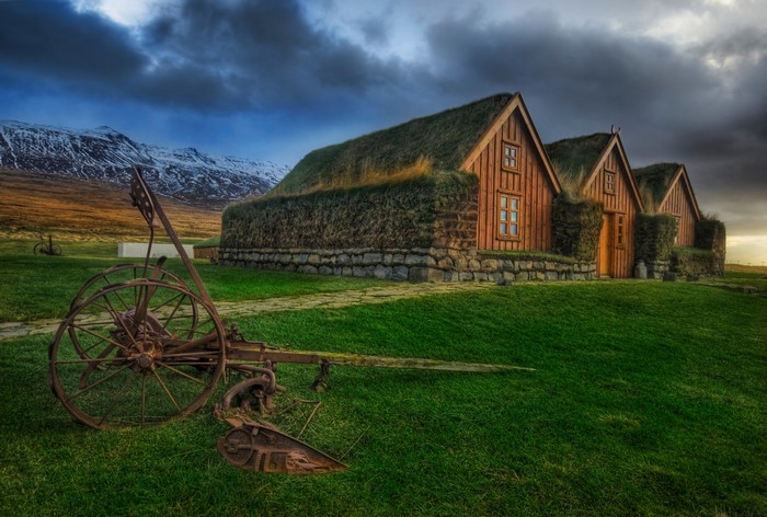 Traditional Icelandic turf houses and old plow
