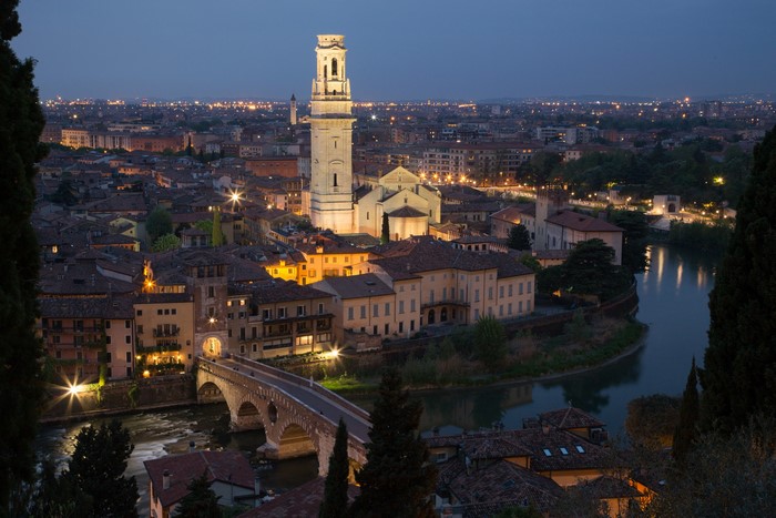 Verona cityscape with river and bridge at dusk