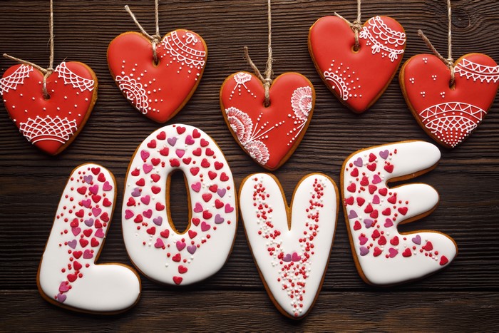 Love spelled with heart-shaped cookies and Valentine's Day cookies