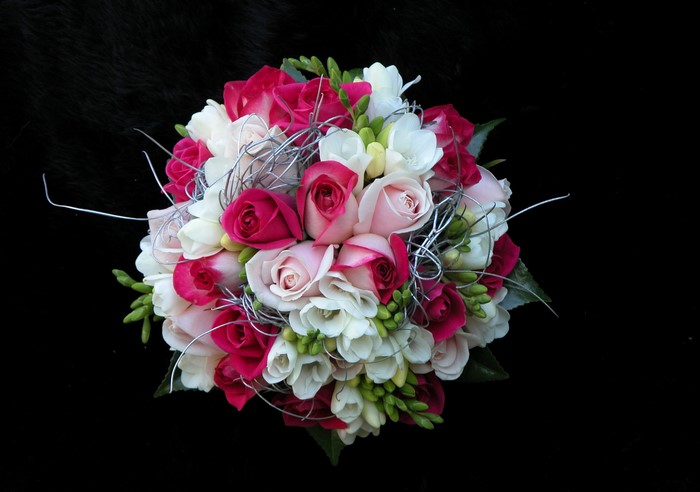 Bouquet of pink, white, and fuchsia roses with freesia