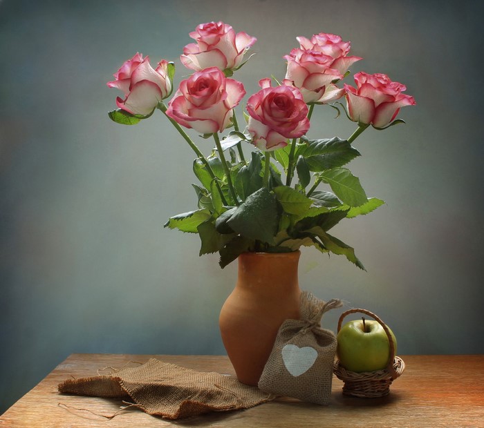 Still-life with pink and white roses in a vase