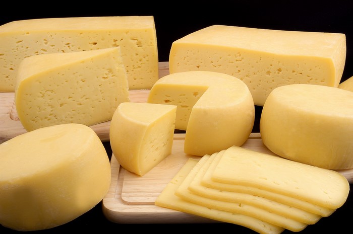 Various cheeses on wooden boards