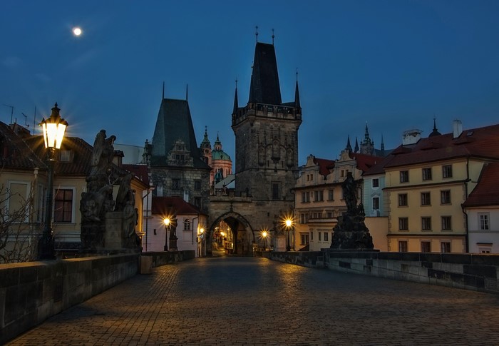 Charles Bridge at night with moon and street lights